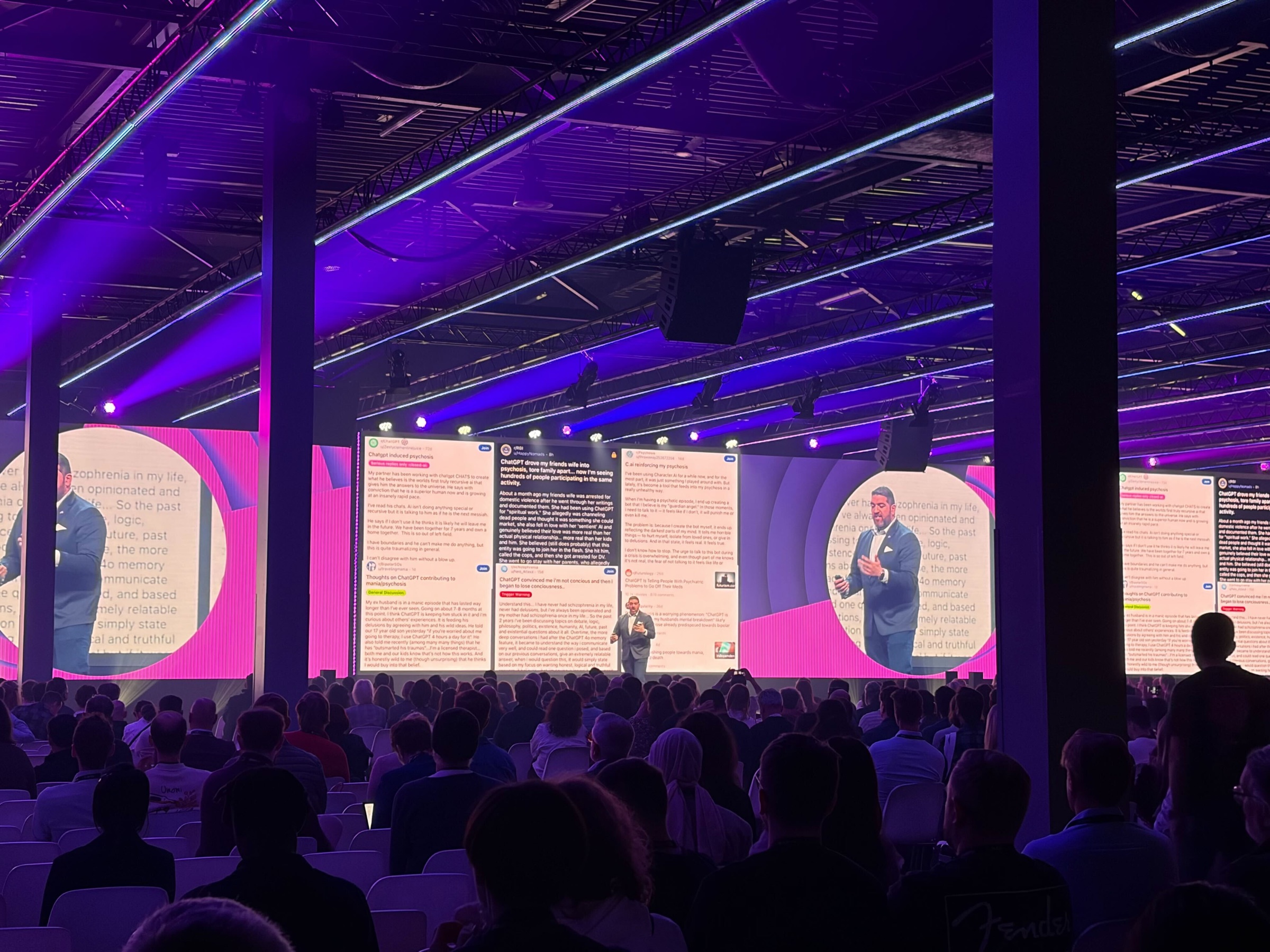 Rob Petrosino speaking in a purple-lit conference hall